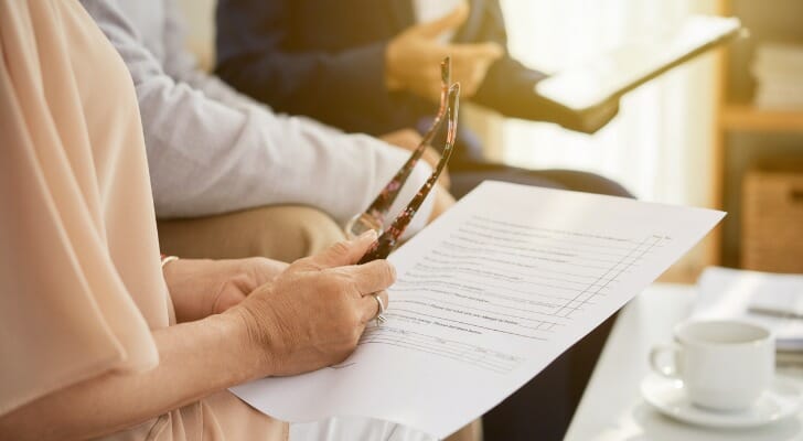 A woman reviewing documents for a retirement budget.