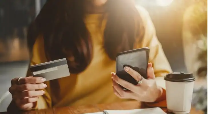 A woman checking on the status of an ACH transfer.
