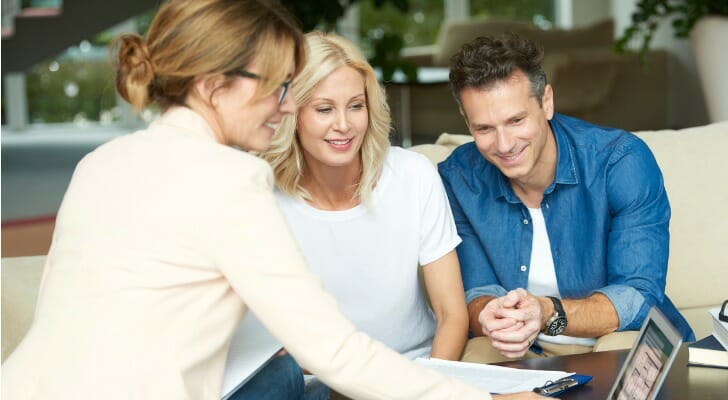 A couple meet with their new advisor, who much adhere to a fiduciary duty.