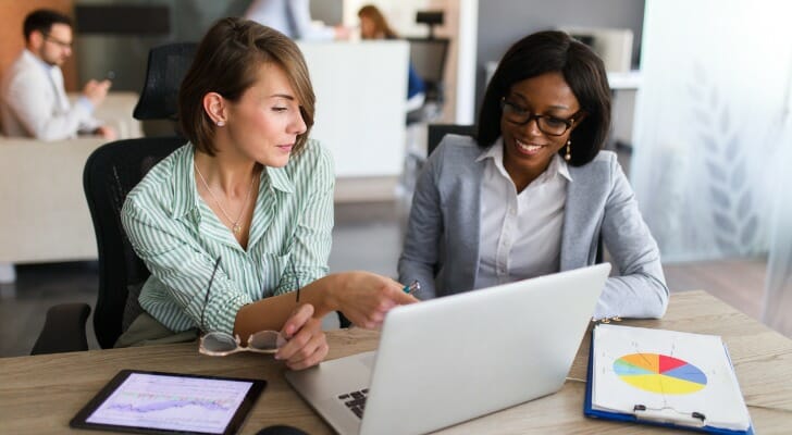 Two advisors study for the CISP exam.