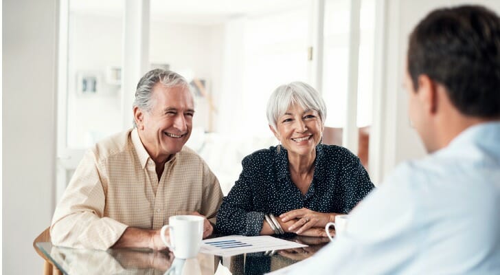 A couple discussing the 401(k) 55 rule with their advisor.