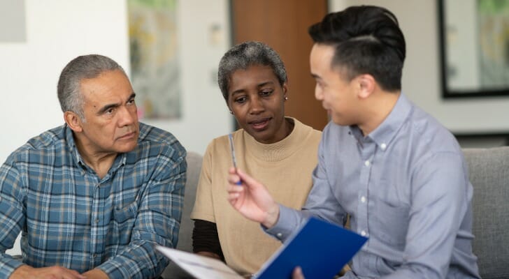 Middle-age couple working with a chartered retirement planning counselor (CRPC).