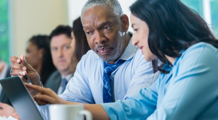 A certified financial education instructor, or CFEI, working with a student.
