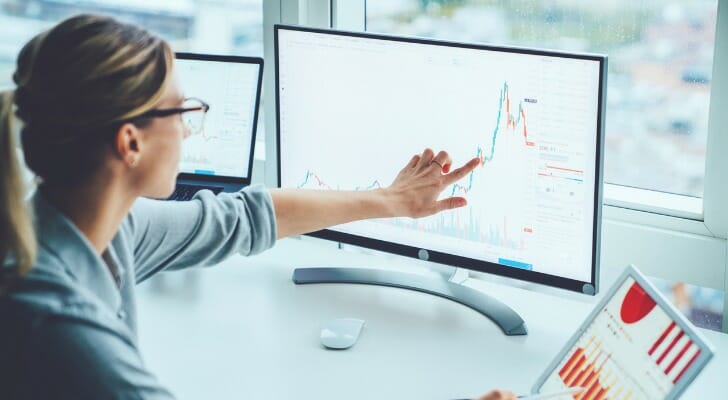 An investor reviewing the differences between the NASDAQ vs. NYSE.