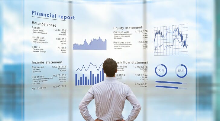 An investor reviews a financial report featuring operating income vs. EBITDA, among other metrics.