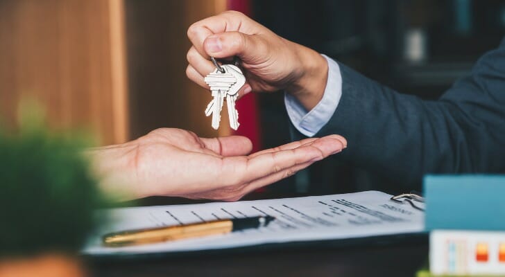 A seller hands the keys to a business over to the buyer.