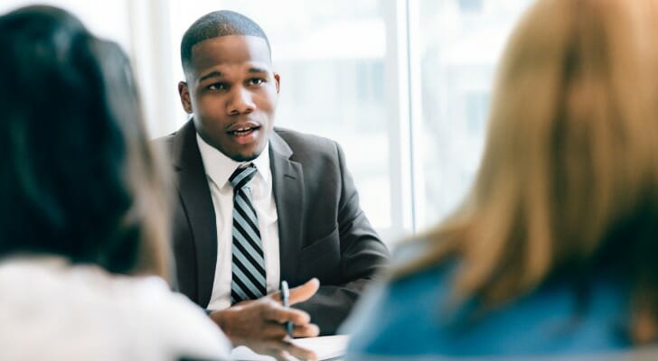 A financial advisor meeting with clients.