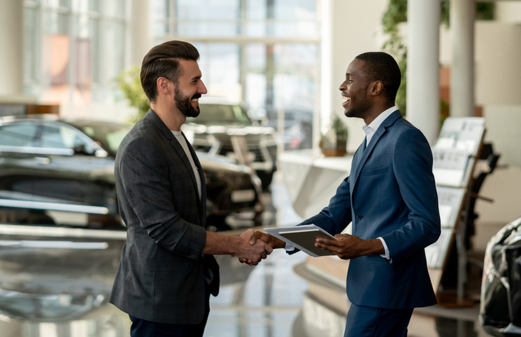 Two man shake hands after selling a business contract.