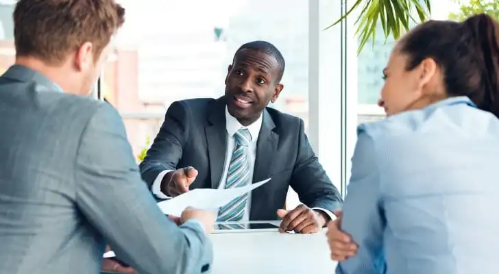 A financial advisor discussing management fees with clients.