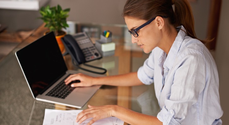 A business owner uses tax software to get their finances in order before it's time to file.