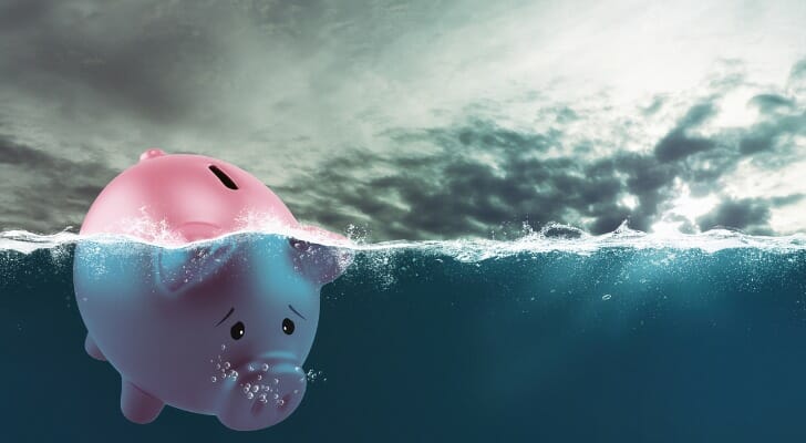 A piggy bank sinks underwater.