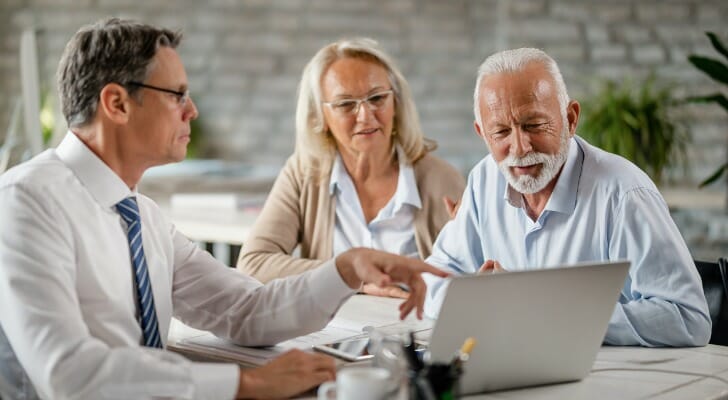 An advisor and clients discuss high volume stocks.