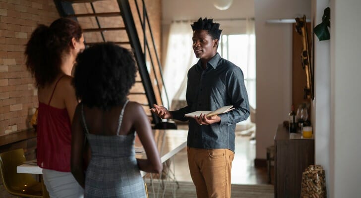 a real estate agent talks to potential residents about the pros and cons of choosing a co op or a condominium