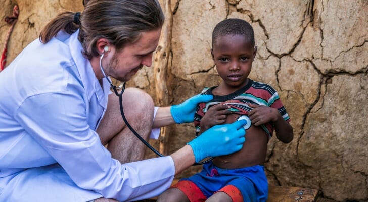 A doctor affiliated with a not-for-profit cares for a child.