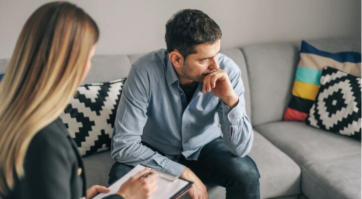A couple creating a checklist to protect their portfolio during an economic downturn.