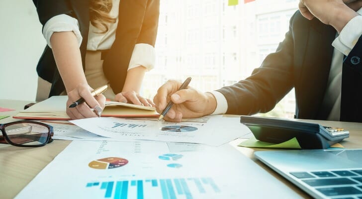 A client service associate talks with her manger