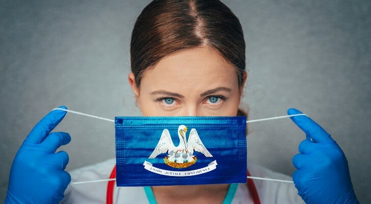A face mask with Louisiana insignia represents the need for coronavirus relief programs in the state