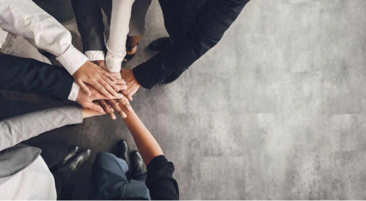 Business partners joining hands.