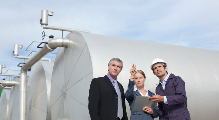 Energy company executives discuss the possible risk to worker safety of expanding their plant.