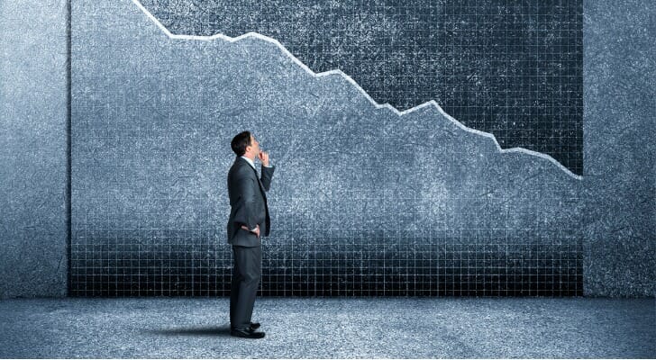 An illustration of a man looking at a declining stock market chart.