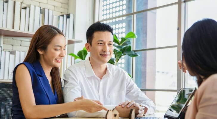 Business owners talking to their lender about what happens if you default on a business loan.