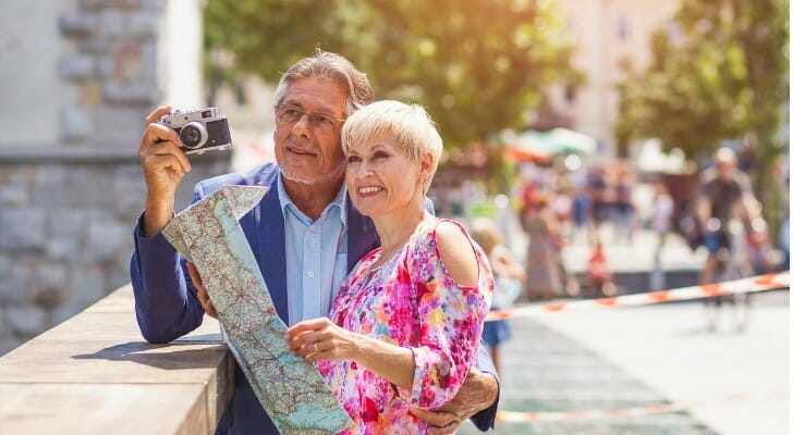 A couple traveling, having done their financial planning for retirement.