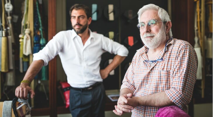 Father and son in their artisanal textile shop.