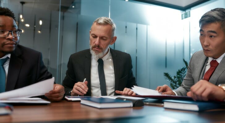 Businessmen discuss an annual report