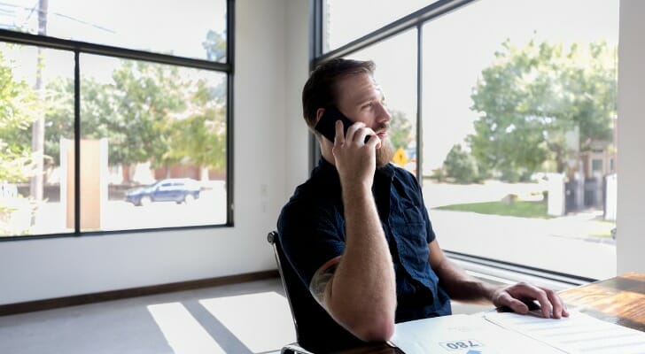 A man on the phone with a credit reporting agency.
