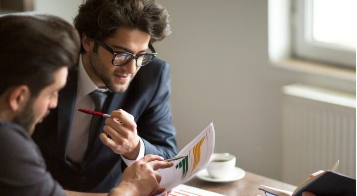 Business partners study a cash flow statement.