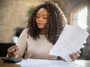 A woman reviewing documents to create a personal financial statement.