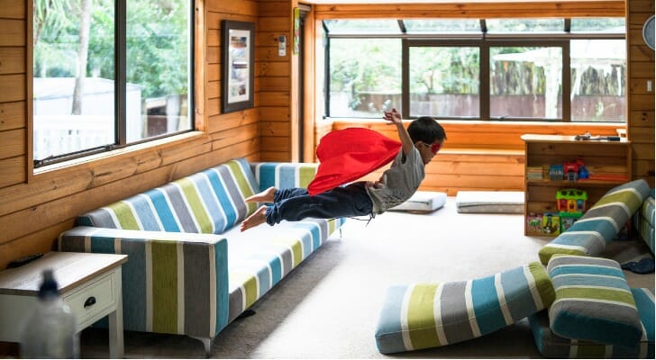 Kid jumping on a sofa