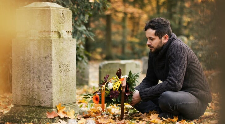 A man visits a loved one's grave.