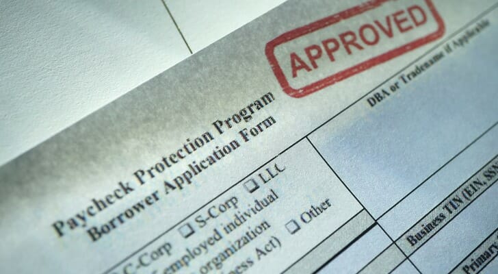 Image shows a Paycheck Protection Program application page with an "APPROVED" stamp in the top right corner. SmartAsset analyzed data from the Small Business Administration and Treasury Department to find the most popular ppp loan lenders in each of the 50 states.