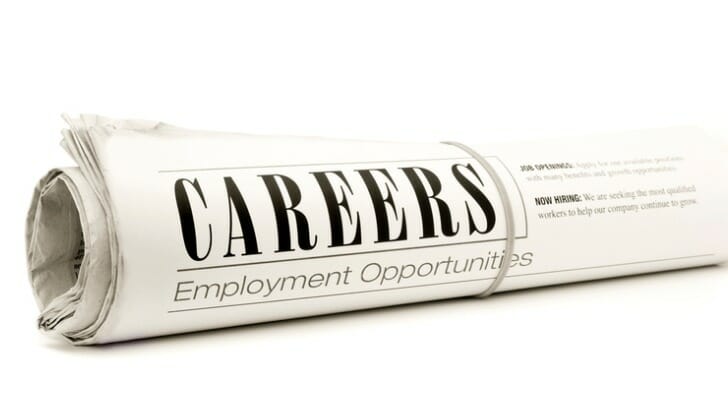 Image shows a rolled up newspaper careers section listing employment opportunities. In this study, SmartAsset finds the best U.S. metro areas for career opportunities in the COVID-19 recession.