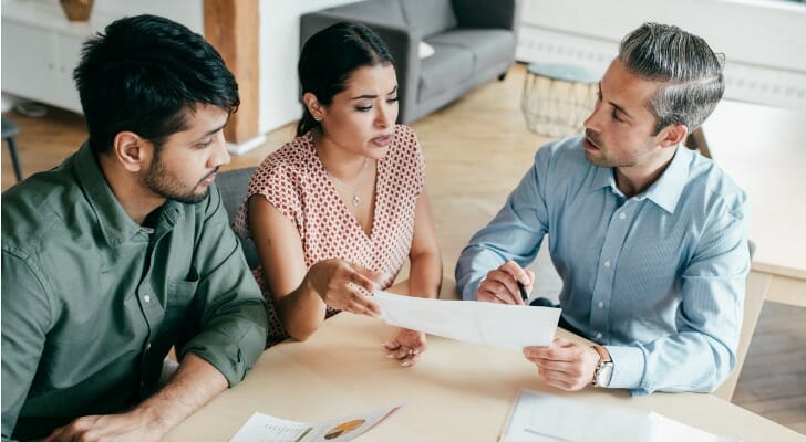 A couple discusses their tax returns with their accountant.
