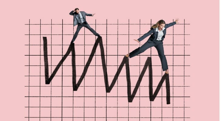 Man and woman balancing on the line of a graph