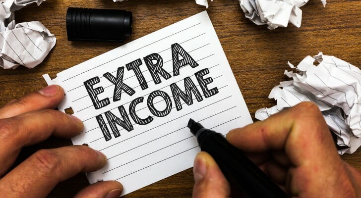"EXTRA INCOME" written on a sheet of paper