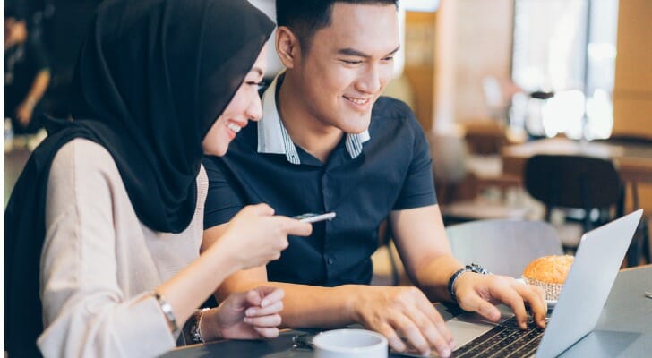 Muslim couple checks their CDs