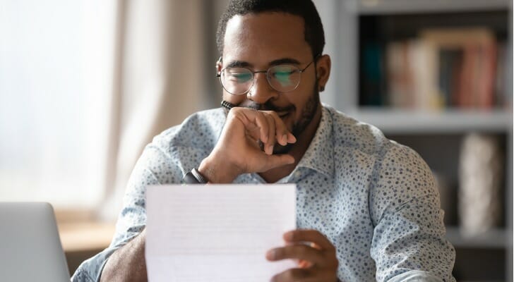 A man reviewing tax documents before itemizing deductions.