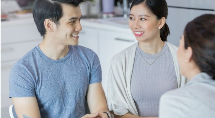 A couple seeks debt counseling with a financial advisor.