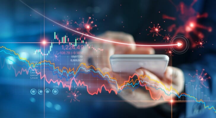 An investor using a phone to invest.