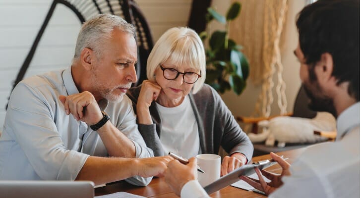A couple review a fiduciary account with their advisor.