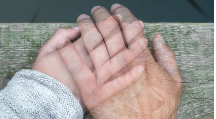 Semi-transparent hand on another hand. Are you responsible for your deceased spouse's death?