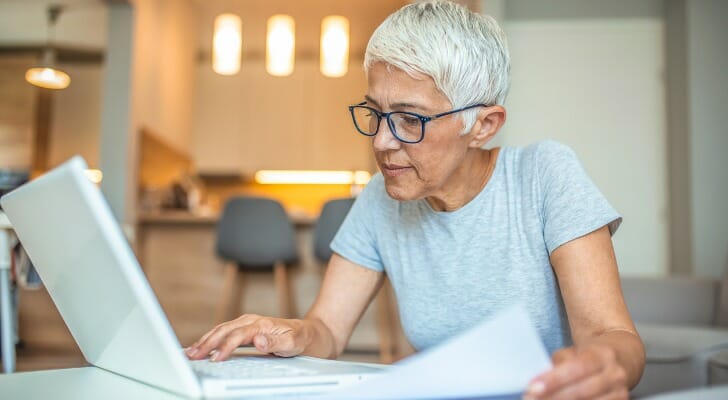 A woman studies a Schedule K-1 form.