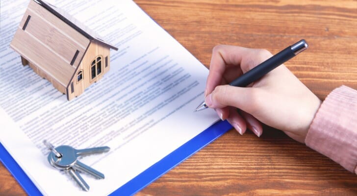 A woman on SSI fills out forms associated with inheriting a home.