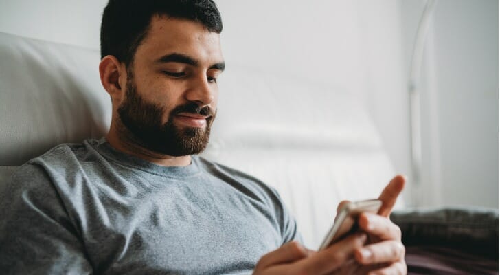 Retail investor using his mobile trading app