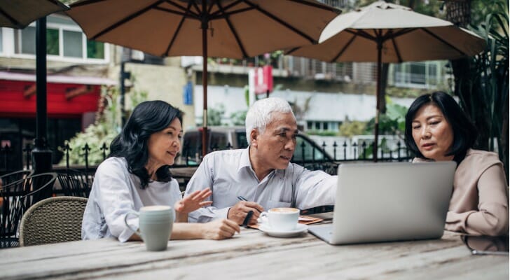A couple going over their holistic financial plan with their advisor.