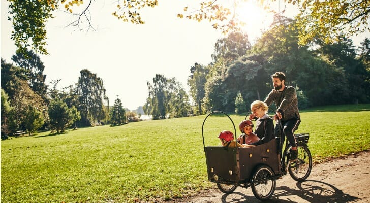 Danish family cycling through a park.