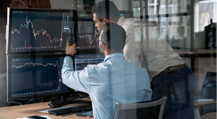 Two investors reviewing potential trades.